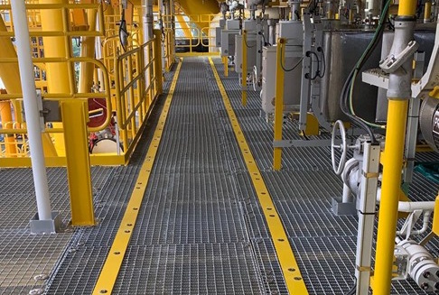 Corrosion-resistant FRP bridge deck covering steel grating in an offshore industrial environment