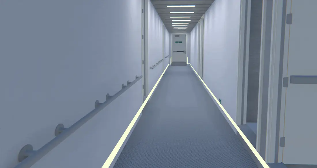 Photoluminescent low location lighting strips illuminating an escape route as the ceiling lights dim